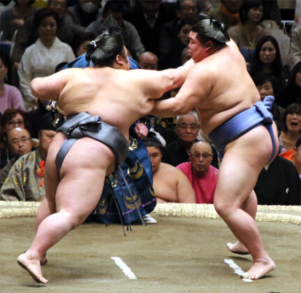 Two sumo wrestlers collide at the tachiai