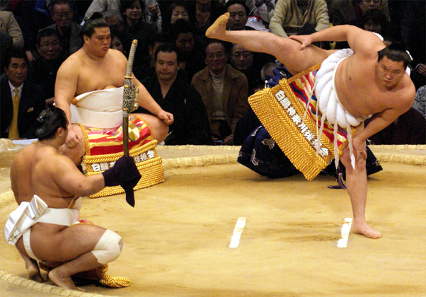 A yokozuna performs the dohyo-iri ring-entering ceremony on the clay dohyo