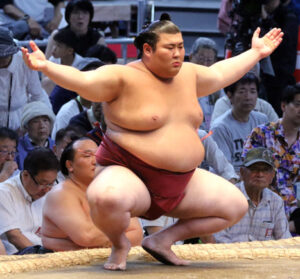 Sumo wrestler Atamifuji crouching at the shikiri line before a bout
